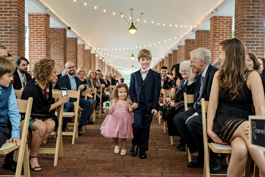 The flower girl and ring bearer walk down the isle during the wedding ceremony at the Shambles in Philadelphia.